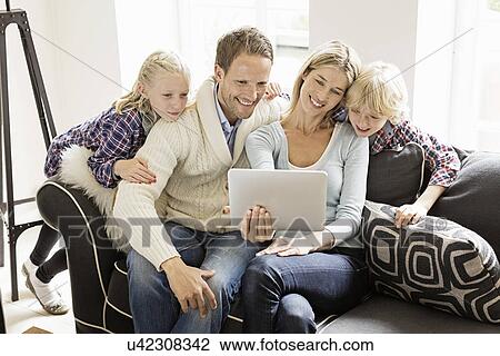 Parents with two children using digital tablet View Large Photo Image Stock Image - Parents with two children using digital tablet. Fotosearch