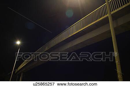 Stock Photo - Pedestrian footbridge at night. Fotosearch