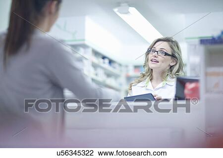 Pharmacist talking to customer View Large Photo Image Stock Image - Pharmacist talking to customer. Fotosearch