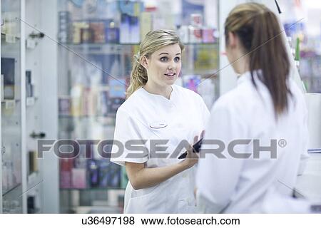Stock Photo - Pharmacists having conversation. Fotosearch