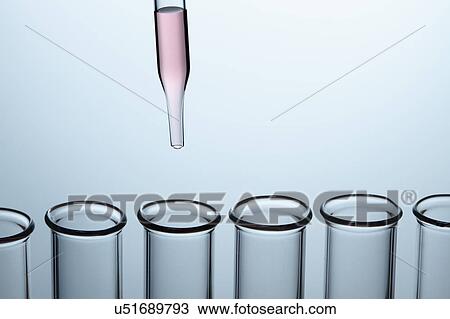 Stock Image - Pipetting: a dropper pipette is used to transfer a small amount of liquid to a test tube. Fotosearch