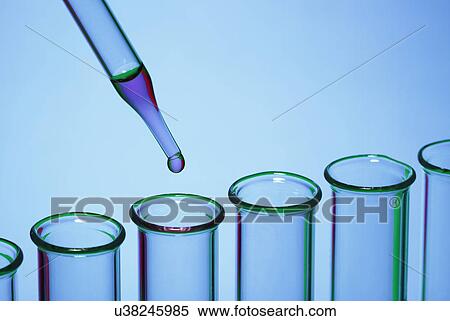 Stock Photography - Pipetting: a dropper pipette is used to transfer a small amount of liquid to a test tube. Fotosearch