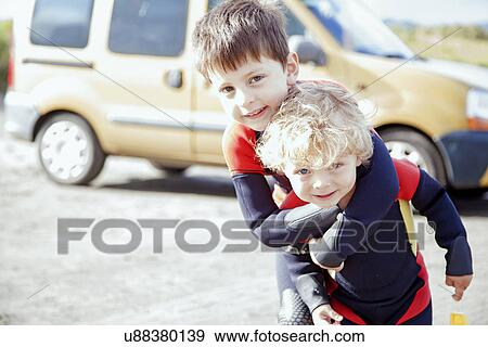 Portrait of brothers wearing wet suits View Large Photo Image Stock Photo - Portrait of brothers wearing wet suits. Fotosearch
