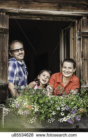 Portrait of family at chalet window, Achenkirch, Tyrol, Austria View Large Photo Image Stock Photo - Portrait of family at chalet window, Achenkirch, Tyrol, Austria. Fotosearch