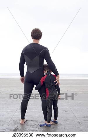 Portrait of father and son on beach, rear view View Large Photo Image Stock Image - Portrait of father and son on beach, rear view. Fotosearch