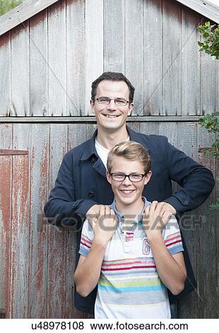 Portrait of father and teenage son in garden View Large Photo Image Stock Photo - Portrait of father and teenage son in garden. Fotosearch