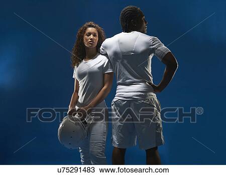 Stock Image - Portrait of female american footballer with trainer. Fotosearch