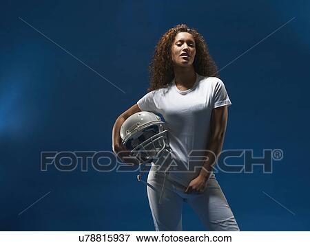 Portrait of female american footballer holding helmet View Large Photo Image Stock Photo - Portrait of female american footballer holding helmet. Fotosearch