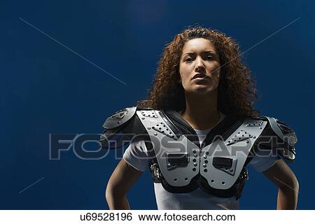 Portrait of female american footballer wearing shoulder pads View Large Photo Image Stock Photograph - Portrait of female american footballer wearing shoulder pads. Fotosearch