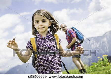 Portrait of girl with father in background, Tyrol, Austria View Large Photo Image Stock Photo - Portrait of girl with father in background, Tyrol, Austria. Fotosearch