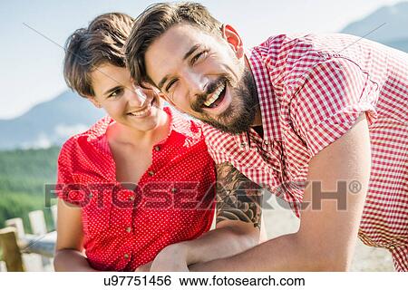 Portrait of happy young couple, Tyrol, Austria View Large Photo Image Stock Photograph - Portrait of happy young couple, Tyrol, Austria. Fotosearch