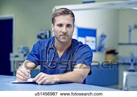 Portrait of male doctor writing up medical notes View Large Photo Image Stock Photo - Portrait of male doctor writing up medical notes. Fotosearch