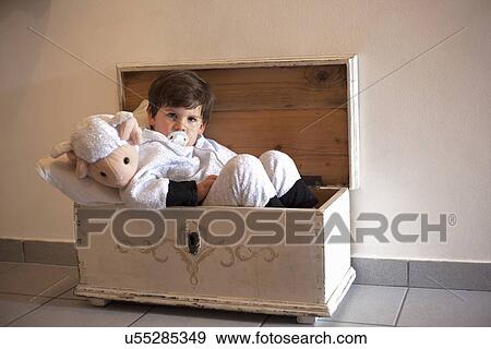 Portrait of male toddler ready for bed in small wooden trunk View Large Photo Image Stock Photo - Portrait of male toddler ready for bed in small wooden trunk. Fotosearch