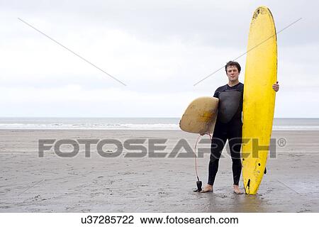Portrait of man with surfboards on beach View Large Photo Image Stock Image - Portrait of man with surfboards on beach. Fotosearch