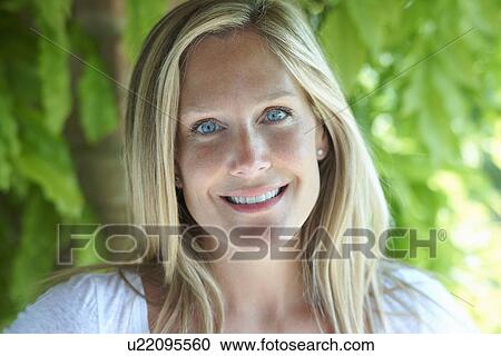 Portrait Of Mature Woman With Blonde Hair And Blue Eyes Stock