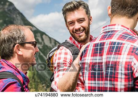 Stock Image - Portrait of men wearing checked shirts. Fotosearch
