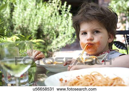 Portrait of messy male toddler eating spaghetti View Large Photo Image Stock Image - Portrait of messy male toddler eating spaghetti. Fotosearch