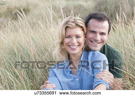 Portrait of mid adult couple in sandunes, Thurlestone, Devon, UK View Large Photo Image Stock Image - Portrait of mid adult couple in sandunes, Thurlestone, Devon, UK. Fotosearch