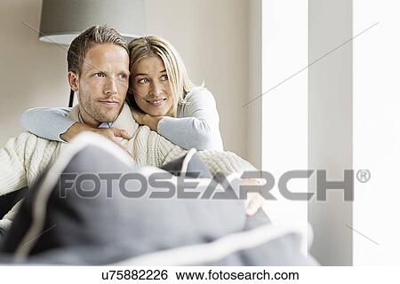 Portrait of mid adult couple looking away View Large Photo Image Stock Photograph - Portrait of mid adult couple looking away. Fotosearch
