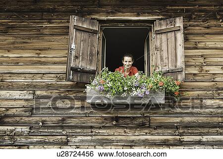 Portrait of mid adult woman at chalet window, Achenkirch, Tyrol, Austria View Large Photo Image Stock Photograph - Portrait of mid adult woman at chalet window, Achenkirch, Tyrol, Austria. Fotosearch