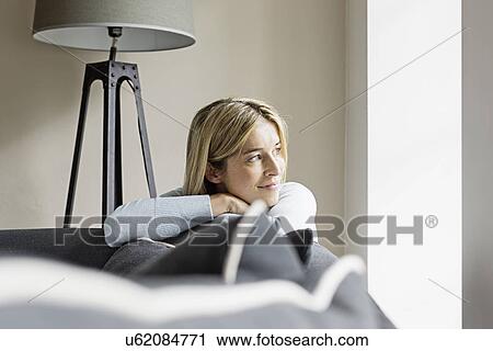 Stock Image - Portrait of mid adult woman looking away. Fotosearch