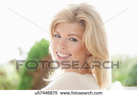 Stock Photography - Portrait of mid adult woman smiling. Fotosearch
