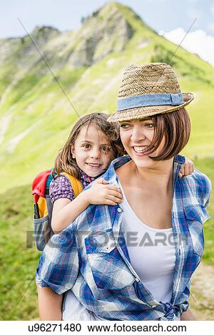 Stock Image - Portrait of mother and daughter smiling, Tyrol, Austria. Fotosearch