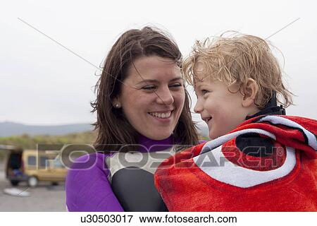 Portrait of mother holding son wrapped in a towel View Large Photo Image Stock Photo - Portrait of mother holding son wrapped in a towel. Fotosearch