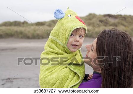 Portrait of mother holding son wrapped in a towel View Large Photo Image Stock Photo - Portrait of mother holding son wrapped in a towel. Fotosearch