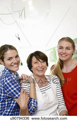 Stock Photograph - Portrait of mother with two daughters. Fotosearch