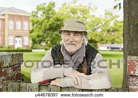 Stock Photo - Portrait of senior man wearing hat. Fotosearch