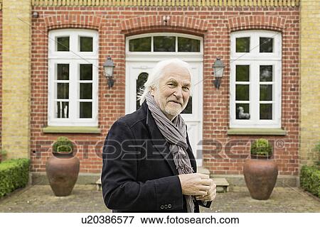 Portrait of senior man wearing jacket and scarf outside house View Large Photo Image Stock Photo - Portrait of senior man wearing jacket and scarf outside house. Fotosearch