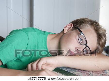 Stock Photograph - Portrait of teenage boy looking bored. Fotosearch