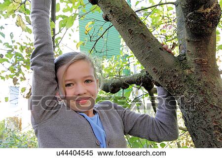 Stock Photography - Portrait of teenage girl in garden. Fotosearch