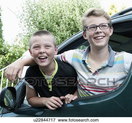 Portrait of two brothers leaning out of car window View Large Photo Image Stock Photo - Portrait of two brothers leaning out of car window. Fotosearch