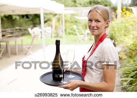Portrait of waitress with tray of wine and glasses in cafe garden View Large Photo Image Stock Photography - Portrait of waitress with tray of wine and glasses in cafe garden. Fotosearch
