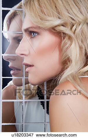Portrait of woman posing against mirror View Large Photo Image Stock Photo - Portrait of woman posing against mirror. Fotosearch