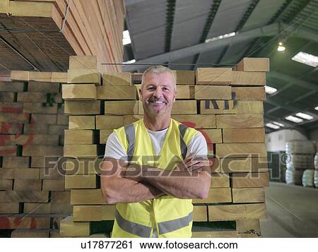 Portrait of worker standing in port store, smiling View Large Photo Image Stock Image - Portrait of worker standing in port store, smiling. Fotosearch