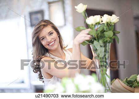 Portrait of young woman arranging roses View Large Photo Image Stock Image - Portrait of young woman arranging roses. Fotosearch