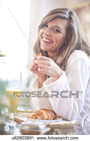 Portrait of young woman having breakfast in bed View Large Photo Image Stock Image - Portrait of young woman having breakfast in bed. Fotosearch