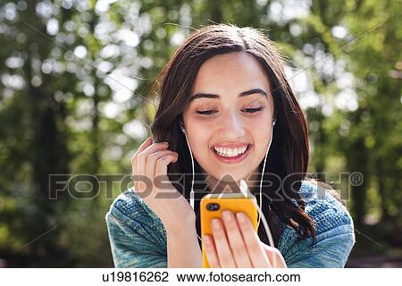 Portrait of young woman listening to music View Large Photo Image Stock Image - Portrait of young woman listening to music. Fotosearch