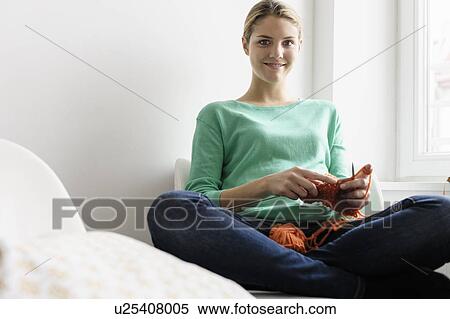 Portrait of young woman on window seat knitting View Large Photo Image Stock Photography - Portrait of young woman on window seat knitting. Fotosearch