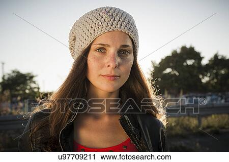 Portrait of young woman wearing beanie View Large Photo Image Stock Image - Portrait of young woman wearing beanie. Fotosearch