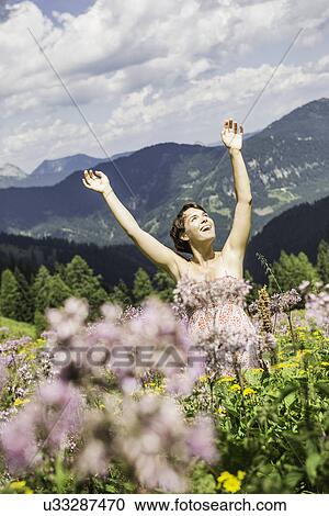 Portrait of young woman with arms up, Tyrol, Austria View Large Photo Image Stock Image - Portrait of young woman with arms up, Tyrol, Austria. Fotosearch