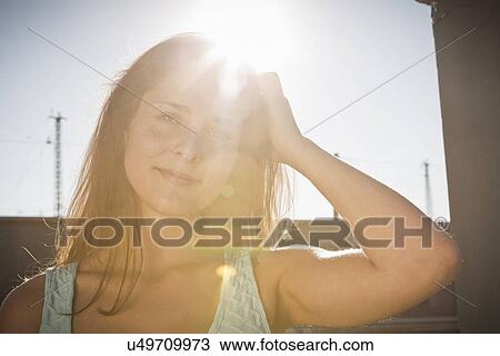 Portrait of young woman with hand in hair View Large Photo Image Stock Image - Portrait of young woman with hand in hair. Fotosearch