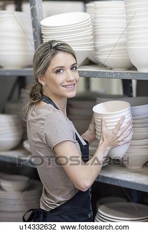 Potter stacking bowls onto shelf at crockery factory View Large Photo Image Stock Image - Potter stacking bowls onto shelf at crockery factory. Fotosearch