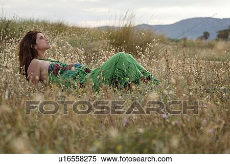 Pregnant woman lying in field View Large Photo Image Stock Photography - Pregnant woman lying in field. Fotosearch