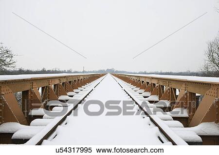 Railway track and bridge in winter snow View Large Photo Image Stock Photography - Railway track and bridge in winter snow. Fotosearch