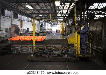 Red hot drive shafts on manipulator ready to unload View Large Photo Image Stock Image - Red hot drive shafts on manipulator ready to unload. Fotosearch