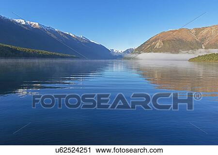 Stock Image - Reflections on lake Rotoiti, Nelson Lakes National Park, South Island, New Zealand. Fotosearch